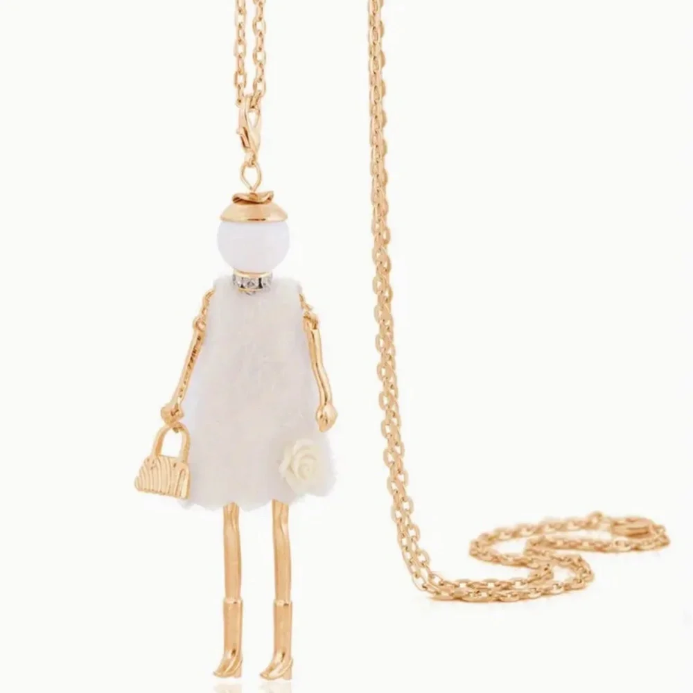 Doll Necklace On Long Chain White Dress With White Flower Lower Front Of Dress